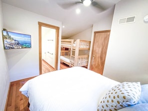 Upstairs bedroom sleeps 4 with queen bed and twin bunk bed with guardrails for younger children.  Private in room bath with shower.  Cable TV with HBO.  Ceiling fan and heater to make sure you are comfortable in summer or winter. 