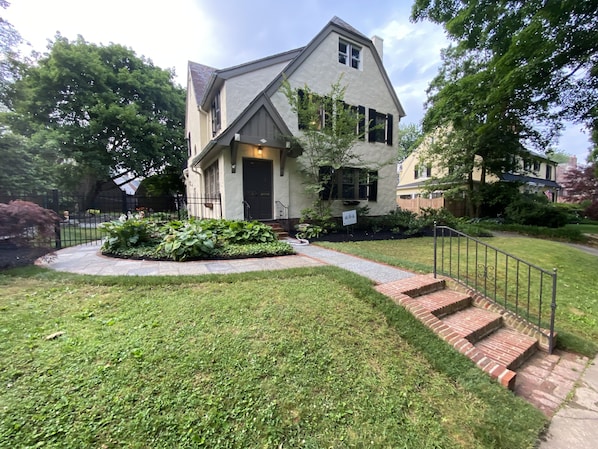 Front yard walkway leading past side yard and back patio to private Studio 