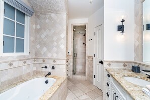 This remodeled full size Primary ensuite features a large soaking tub with jets, walk-in shower.