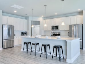 Kitchen area with stainless steel appliances and spacious island
