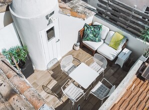 Roof terrace - a table for 4 a comfy sofa for lounging - parasol and cushions 