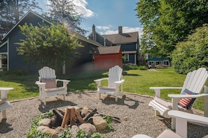 Relax at the fire pit also shared with the William Home guests. The Smith Cottage is on the left, and the red shed is where I keep bundles of wood. The Williams is beyond.