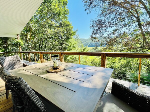 Upper patio outdoor dining options with tree top mountain view  