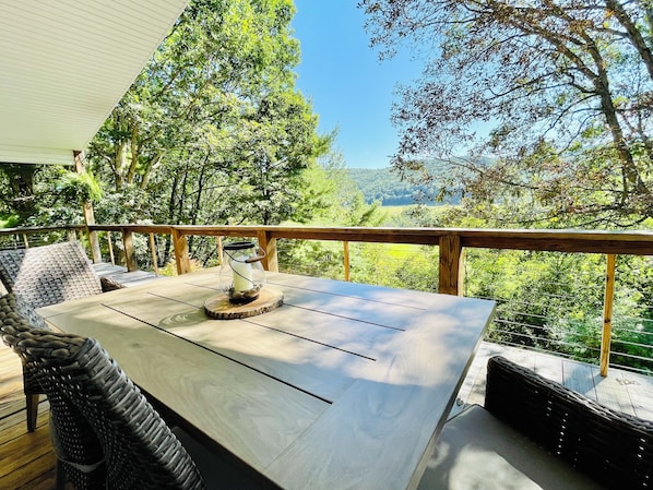 Upper patio outdoor dining options with tree top mountain view