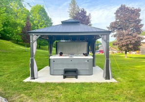 Enjoy soaking up in the large hot tub surrounded by nature