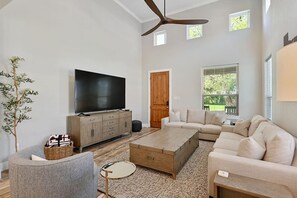 Spacious living room, abundant seating for comfort and socializing.