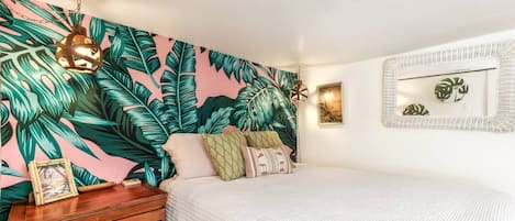 Relax in a cozy, tropical haven with plush queen bed.