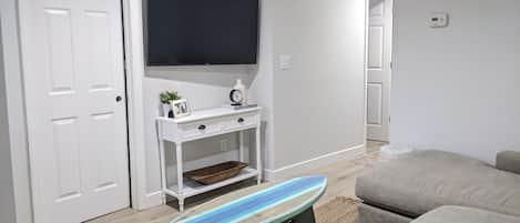 Living room with surfboard table and big screen TV with Cable, Internet & WiFi