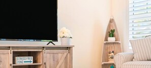 Comfortable living room with a flat-screen TV, comfortable seating, and a stylish coffee table. Enjoy your downtime in this relaxing space.