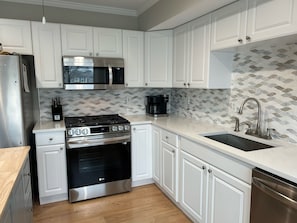 Fully stocked kitchen. New appliances, new quartz countertop and backsplash