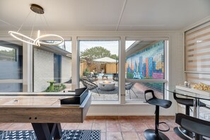 Game room overlooking the gorgeous backyard!