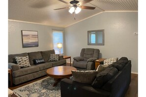 Living room with sleeper sofa, couch and a recliner.