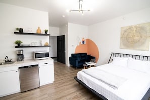 Studio Apartment living area with kitchenette and desk