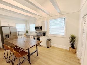Dining room with vaulted ceilings. Create and eat amazing meals with this fully stocked kitchen