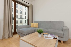 Relax in the stylish living room with a comfortable corner sofa and modern decor.