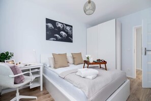 The cosy bedroom features a luxurious double bed and ample storage.
