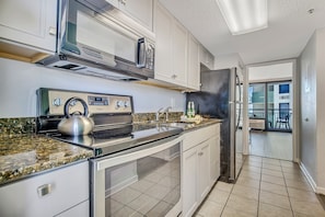 Step into our suite's kitchen, a gourmet haven equipped with modern appliances, sleek countertops, and everything you need to whip up a culinary masterpiece!