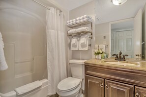 Discover refreshing simplicity in our bathroom, with a refreshing bathtub, a functional sink, and a toilet, providing a straightforward and revitalizing space!