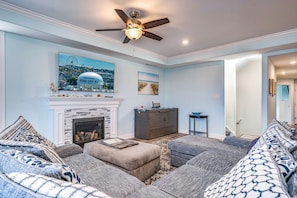 Spacious living room with a large sectional sofa, fireplace, and flat-screen TV.