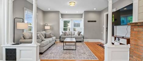 Living Room flows into Office/mixed use area with Ornamental fireplace starring gleaming hardwoods and beautiful architecture