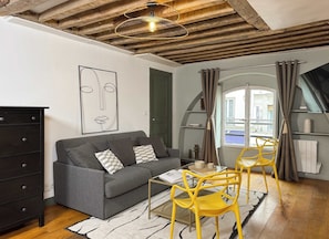 A cozy living room with a double sofa.