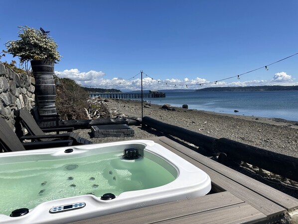 Outdoor spa area with hot tub and firepit