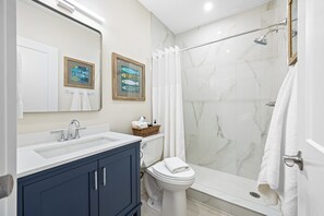 A chic and modern bathroom with a walk-in shower, stylish vanity, and premium finishes.Y