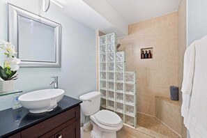 Bright and stylish bathroom featuring a tiled shower, and minimalist design