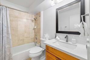 Bright and stylish bathroom featuring a tiled shower, and minimalist design