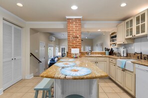 The open kitchen overlooks the sunken den.