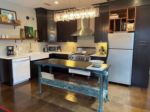 Kitchen includes Viking Range, Refrigerator, Microwave, Toaster, Coffee Station, KitchenAid Mixer.  Socialize over the industrial island while chatting with those in the living/dining rooms.