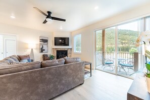 Living area featuring cozy furnishings, a gas fireplace, and mounted smart TV.