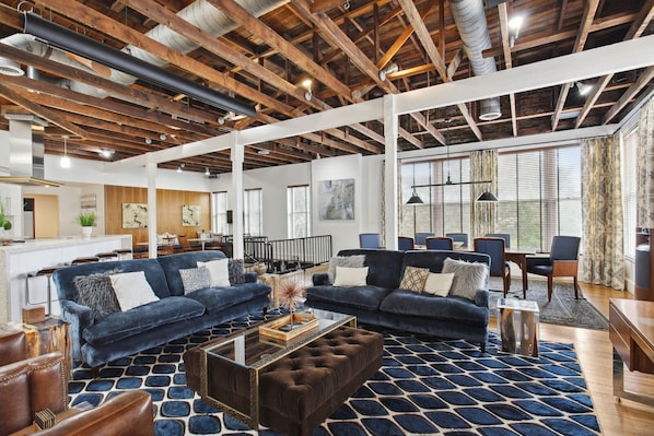 Lush, open loft! - Midnight blues, velvets & leather play against the exposed beams and pine floors!