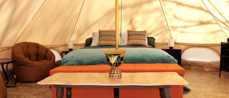 16' diameter bell tent with platform bed, down alternative mattress and comfy bedding