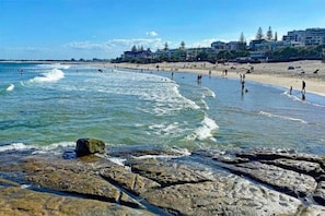 The beach is a short walk out the front door and across the road.