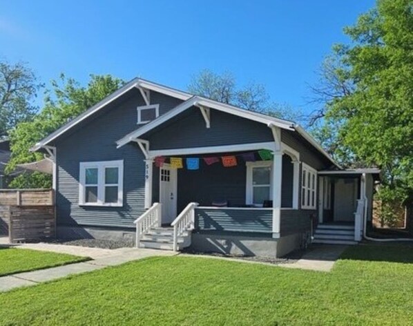 Exterior and fenced front yard with porch for morning coffee! 