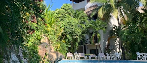 Garden oasis style pool with tranquil waterfall feature.