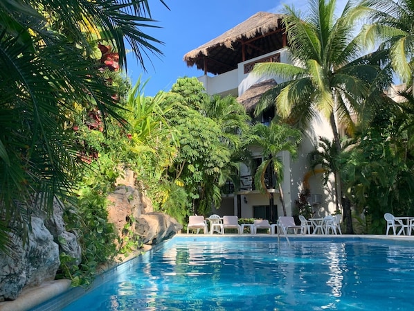 Garden oasis style pool with tranquil waterfall feature.