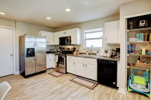 Fully stocked kitchen with stainless steel appliances and kids high chair!