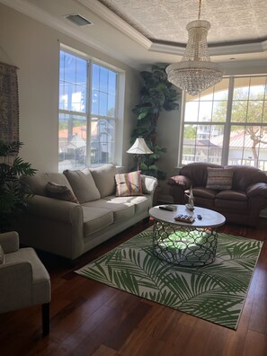 Cozy sitting room adjacent to family room w/ large TV; separated w/ French doors