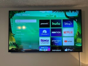 65 inch smart TV in the bedroom with cable and sports! Sign in to your streaming services too!