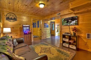 Cozy game room with arcade machine and TV, perfect for family fun.