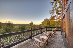 Expansive deck with rocking chairs and breathtaking mountain views.