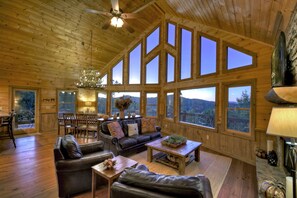 Living room with floor-to-ceiling windows and mountain views.