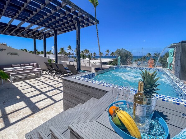 Heated ,jetted hot tub with cascading waterfall over looks the ocean