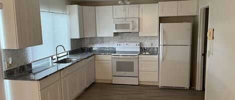 New Kitchen with new refrigerator, dishwasher, range, microwave and washer/dryer