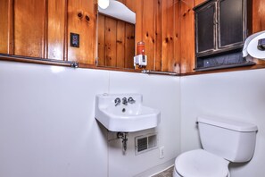 small quaint bathroom located off of kitchen