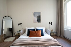 Dream easy in this serene bedroom with touches of modern art.