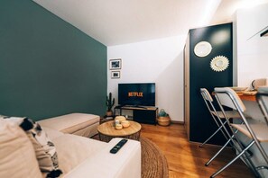 Cozy living area with a stylish sofa and flat-screen TV, providing a great spot to unwind and enjoy your favorite shows.