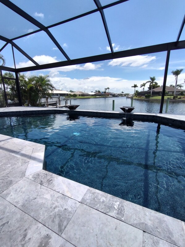 Heated pool, sunny in winter. Landscaping and wide canal make it very private.